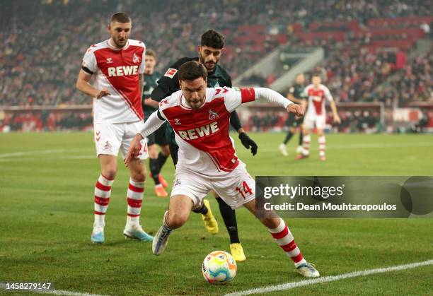 Jonas Hector of 1.FC Koln is challenged by Eren Dinkci of SV Werder Bremen during the Bundesliga match between 1. FC Köln and SV Werder Bremen at...
