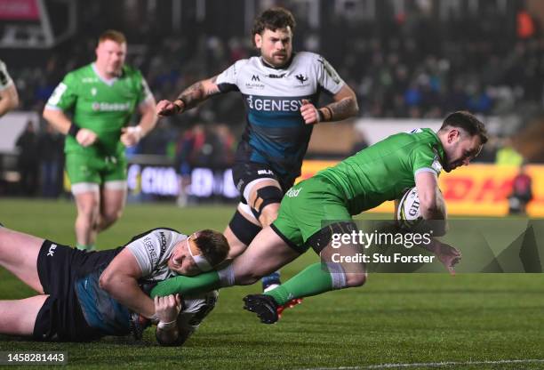 Falcons player Michael Young breaks the tackle of Shane Delahunt to score the opening try during the Pool A Challenge Cup match between Newcastle...