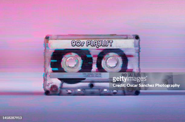 front view of a cassette audio tape with glitch vhs effect and 90s playlist text in label - audio cassettes photos et images de collection