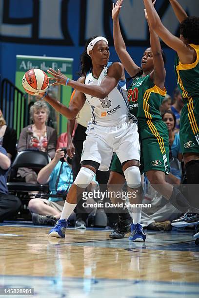 Taj McWilliams-Franklin of the Minnesota Lynx tries to pass the ball against Camille Little of the Seattle Storm in the game on June 6, 2012 at...