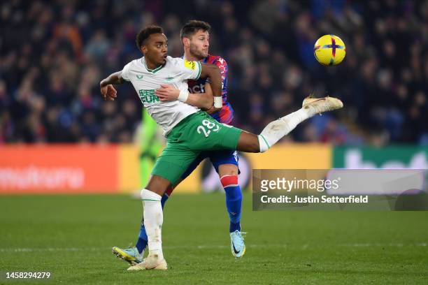 Joe Willock of Newcastle United holds off Joel Ward of Crystal Palace during the Premier League match between Crystal Palace and Newcastle United at...
