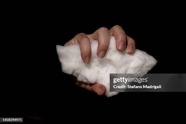piece of ice tight in one hand - freezing hands stockfoto's en -beelden