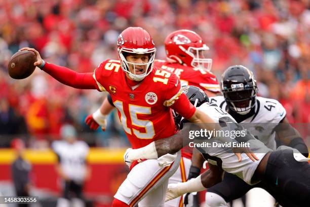 Patrick Mahomes of the Kansas City Chiefs scrambles against Devin Lloyd of the Jacksonville Jaguars during the first quarter in the AFC Divisional...