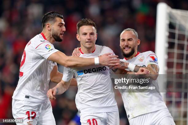 Ivan Rakitic of Sevilla FC celebrates after scoring the team's first goal from a penalty with teammates Rafa Mir and Nemanja Gudelj during the LaLiga...