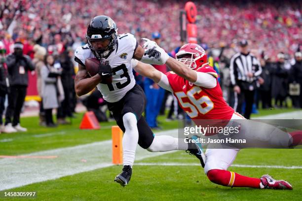 Christian Kirk of the Jacksonville Jaguars scores a 10 yard touchdown against George Karlaftis of the Kansas City Chiefs during the first quarter in...