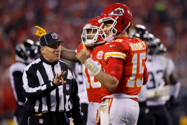 Patrick Mahomes of the Kansas City Chiefs talks with referee Paul King about contesting a first down against the Jacksonville Jaguars during...