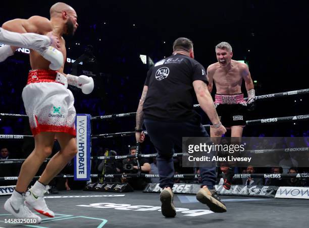 Liam Smith celebrates with their coaching team as the Referee calls the fight and Chris Eubank Jr reacts, after Chris Eubank Jr is knocked down for a...