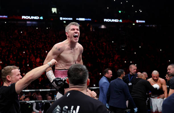 Liam Smith is carried by their coaching team as they celebrate after defeating Chris Eubank Jr during the Middleweight fight between Chris Eubank Jr...