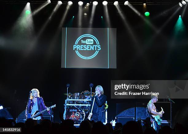 Def Leppard's Rick Savage Joe Elliott, Rick Allen, Phil Collen perform at YouTube Presents Def Leppard At The House Of Blues at House of Blues Sunset...