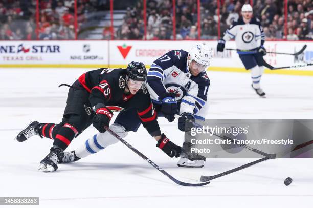 Parker Kelly of the Ottawa Senators battles for the puck with Adam Lowry of the Winnipeg Jets during the first period at Canadian Tire Centre on...