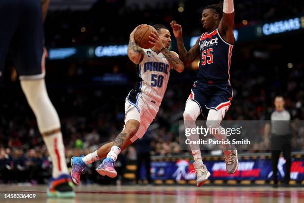 Cole Anthony of the Orlando Magic dribbles in front of Delon Wright of the Washington Wizards during the first half at Capital One Arena on January...