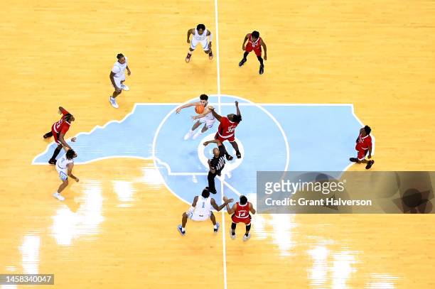 Pete Nance of the North Carolina Tar Heels and D.J. Burns Jr. #30 of the North Carolina State Wolfpack tip off to begin their game at the Dean E....