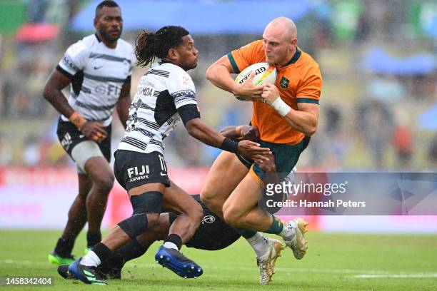 James Turner of Australia is tackled during the 2023 HSBC Sevens match between Fiji and Australia at FMG Stadium on January 22, 2023 in Hamilton, New...