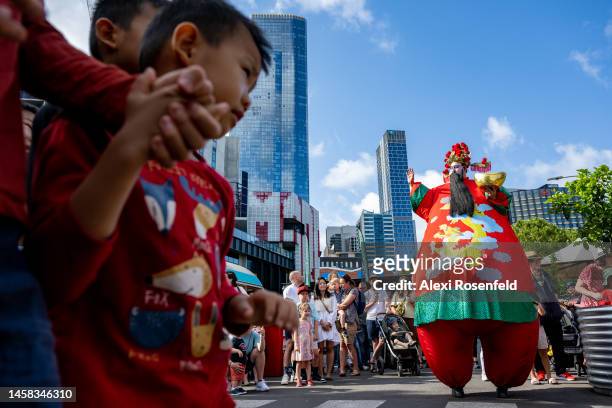People gather around to watch members of the Vietnamese Buddhist Youth Association perform the dragon dance at Victoria Market on January 22, 2023 in...