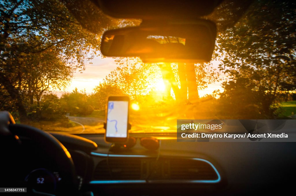 View through vehicle window past mobile phone map
