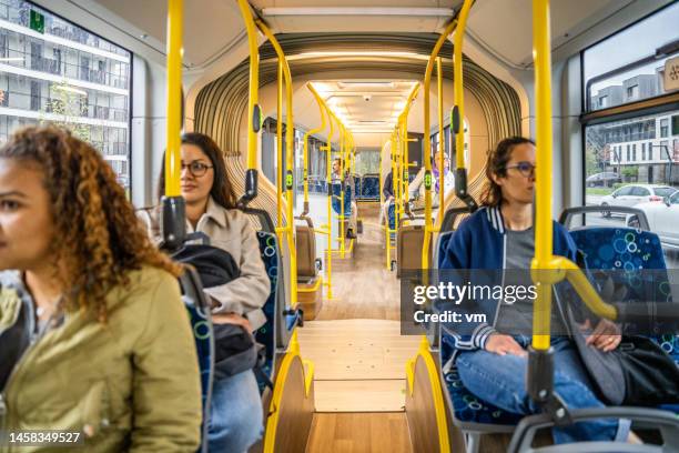 diverse passengers riding bus and sitting at seats - vehicle interior stock pictures, royalty-free photos & images