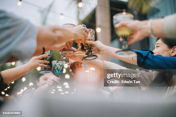 close up asian chinese friends celebration toasting outdoor dining - light hands bildbanksfoton och bilder