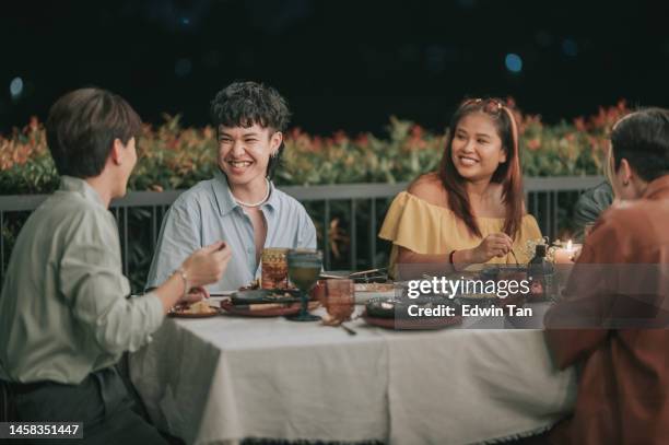 outdoor dining asian chinese friends in the evening enjoying dinner - candle light dinner stock pictures, royalty-free photos & images