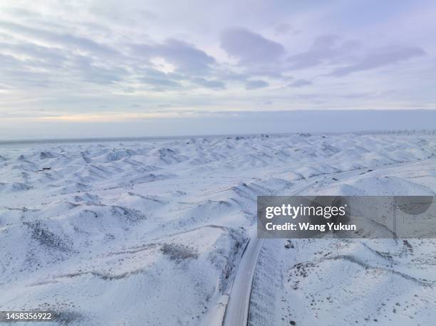 the rolling hills are covered in thick snow - bumpy road stock pictures, royalty-free photos & images