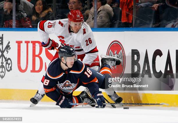 Paul Stastny of the Carolina Hurricanes trips up Anthony Beauvillier of the New York Islanders during the third period at UBS Arena on January 21,...