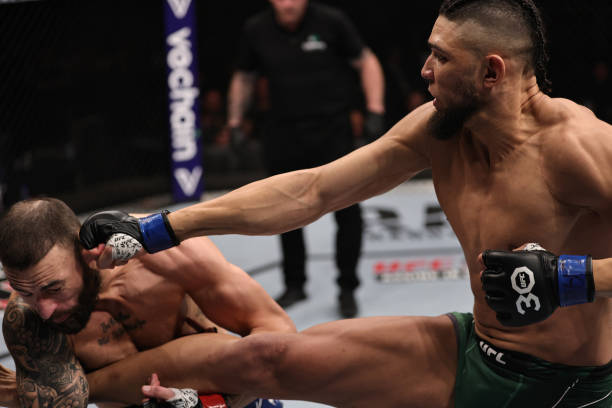 Johnny Walker of Brazil punches Paul Craig of Scotland in a light heavyweight fight during the UFC 283 event at Jeunesse Arena on January 21, 2023 in...