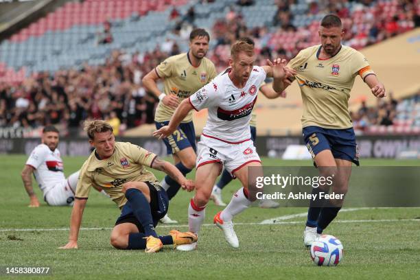 Oliver Bozanic of Western Sydney contests the ball against Matthew Jurman of the Jets with team mates during the round 13 A-League Men's match...