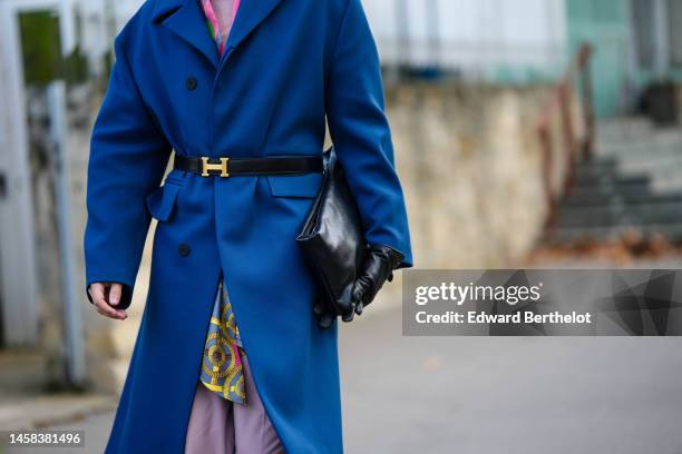 Guest wears a pale purple ribbed wool turtleneck pullover, a neon pink / green / gray print pattern silk scarf, a blue long wool coat, a black shiny...