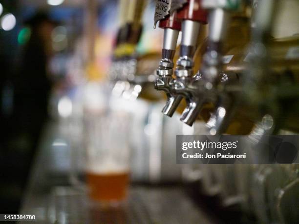 cold beer on tap in a pub - denver art stock pictures, royalty-free photos & images