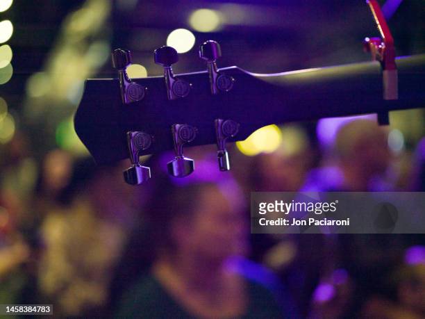 focus on guitar neck over a crowd - rock band stock pictures, royalty-free photos & images