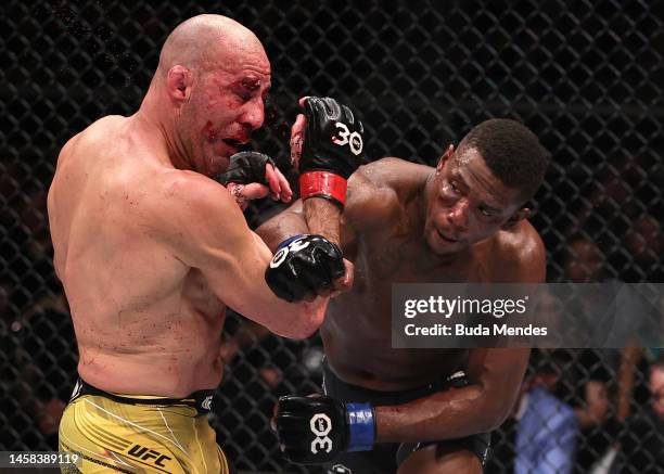 Jamahal Hill punches Glover Teixeira of Brazil in the UFC light heavyweight championship fight during the UFC 283 event at Jeunesse Arena on January...