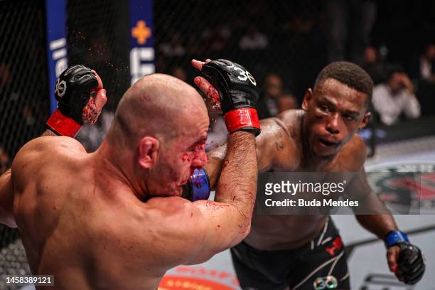 Jamahal Hill punches Glover Teixeira of Brazil in the UFC light heavyweight championship fight during the UFC 283 event at Jeunesse Arena on January...