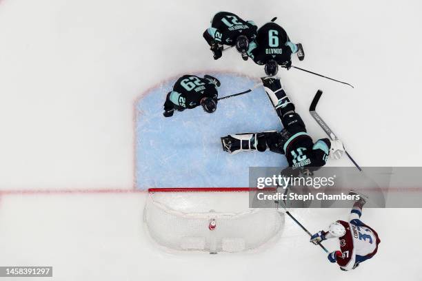 Philipp Grubauer of the Seattle Kraken makes a save against J.T. Compher of the Colorado Avalanche during the second period at Climate Pledge Arena...