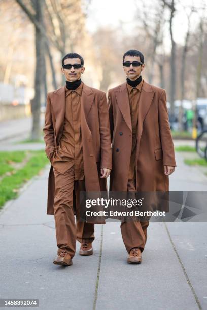 Guests wear black sunglasses, a black turtleneck pullover, a camel tie, a matching camel shirt, a matching camel long coat, matching camel suit...