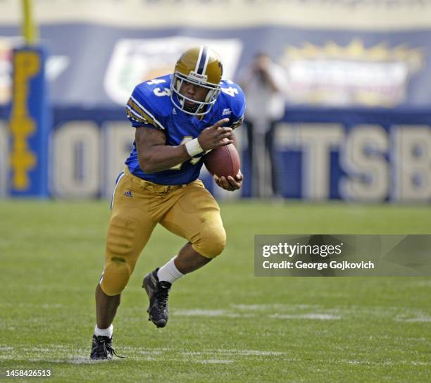 Running back Raymond Kirkley of the University of Pittsburgh Panthers runs with the football against the Youngstown State Penguins during a college...