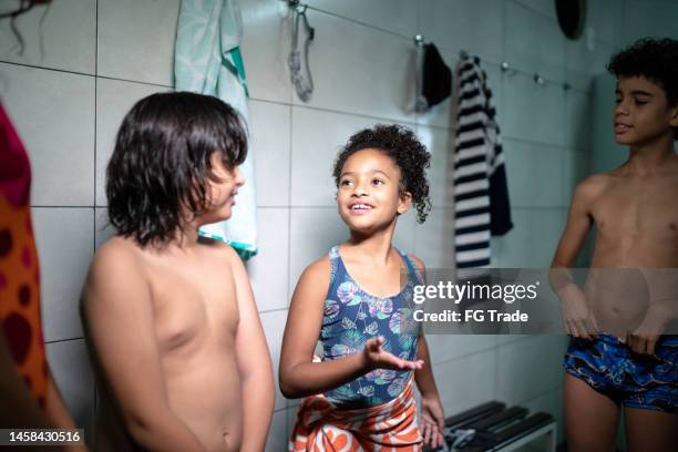 children talking in the swimming club locker room - preteen girl no shirt stock pictures, royalty-free photos & images