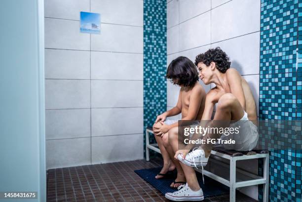 boys talking while getting ready in the swimming club locker room - young boys changing in locker room 個照片及圖片檔