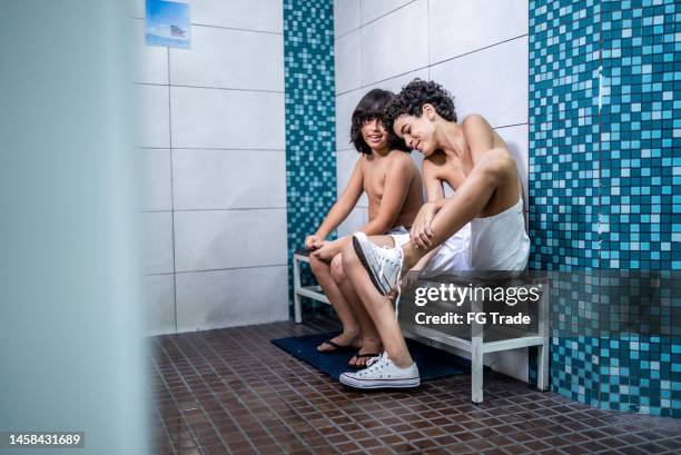 boys talking while getting ready in the swimming club locker room - young boys changing in locker room stock pictures, royalty-free photos & images