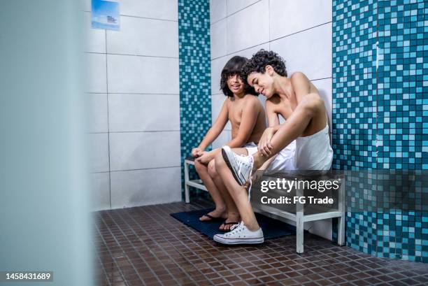 boys talking while getting ready in the swimming club locker room - young boys changing in locker room imagens e fotografias de stock