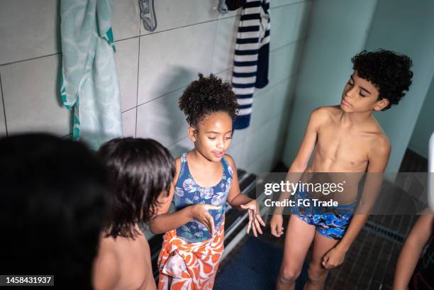 kids talking in the swimming club locker room - young boys changing in locker room 個照片及圖片檔