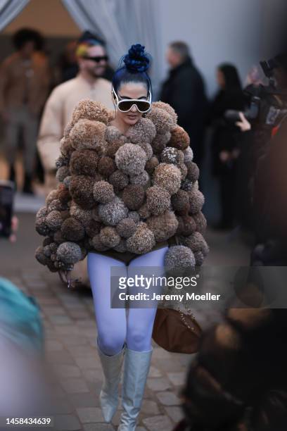Sita Abellan seen wearing a brown puffer jacket with fur details, a purple leggings, high green boots and white Loewe sunglasses , outside Loewe...