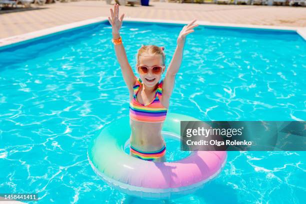 inflatable safety rings for children. girl with colorful ring in the pool - tube girl bildbanksfoton och bilder