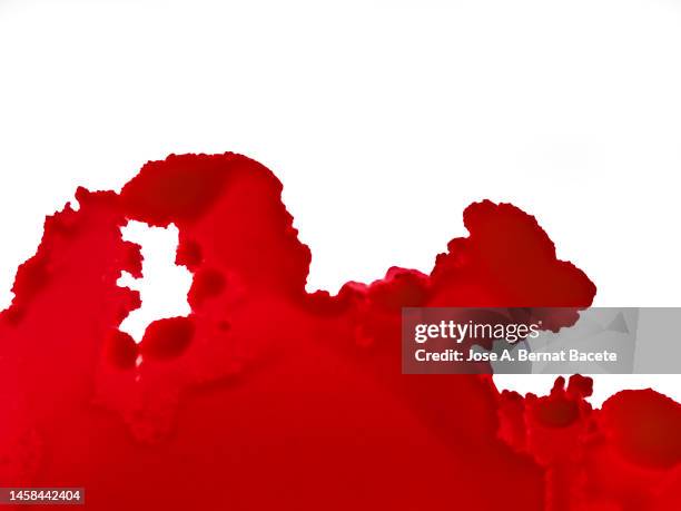 drop of blood slides on a white surface. - bloody death stock pictures, royalty-free photos & images