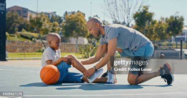 sport injury outdoor with man, kid and injured knee with pain, basketball accident on basketball court in park. black man help boy, sports emergency and check wound with father and son with care - injured knee stock pictures, royalty-free photos & images