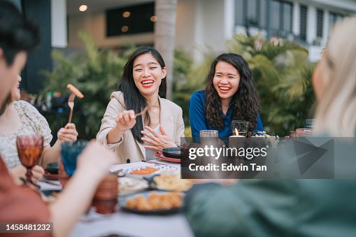 Asian Chinese Lesbian couple and Friends enjoying outdoor dining together Asian Chinese Lesbian couple and Friends enjoying outdoor dining together