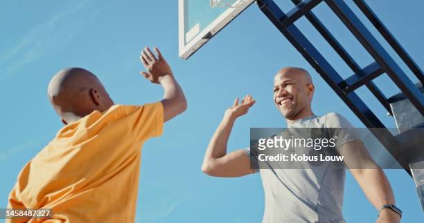 high five, fitness and basketball teamwork of male friends outdoor feeling happy about training. exercise, basketball court and black man smile about game success together with happiness from sports - black man high 5 stock pictures, royalty-free photos & images