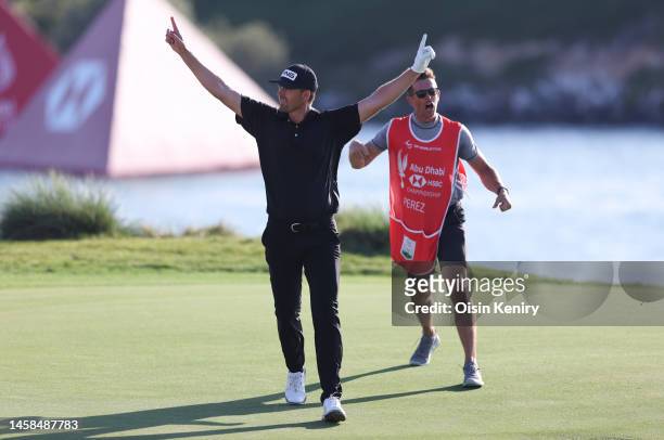 Victor Perez of France and his caddie James Erkenbeck celebrate after a birdie on the seventeenth hole during the final round of the Abu Dhabi HSBC...