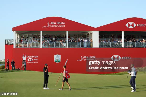 Victor Perez of France celebrates after finishing his round on the eighteenth green with his caddie, James Erkenbeck during the final round of the...