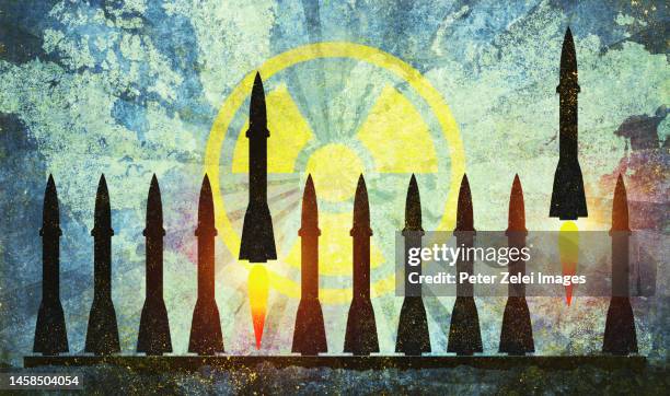 nuclear missiles with radioactive warning symbol and world map - radiation symbol stock pictures, royalty-free photos & images