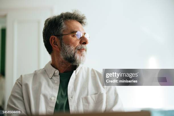 portrait of a senior businessman working at home - mature men office stock pictures, royalty-free photos & images