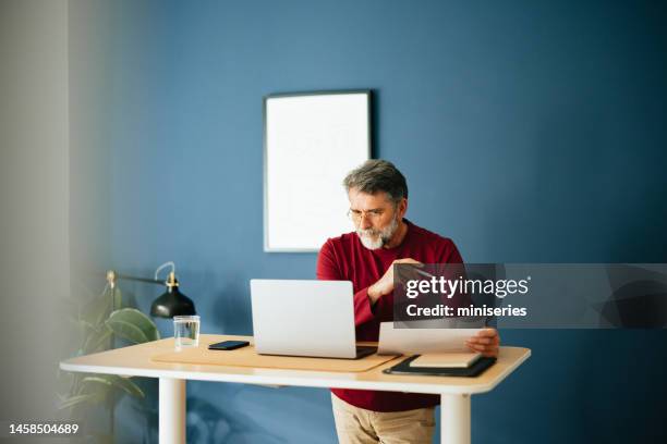 senior businessman working in his modern office - standing desk laptop stock pictures, royalty-free photos & images